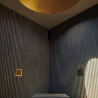 A view from inside the chapel, featuring a view of the sky above through the circular roof.