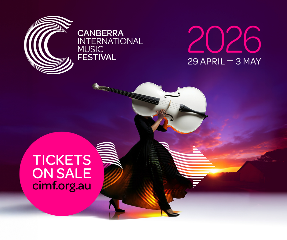 Women in black evening gown carrying a white cello dramatically above her head obsuring her face with a sunset background