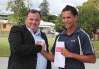 Senior school student Mr Anthony Walker (right) receives his prize from CSU's Mr Ray Eldridge.