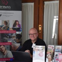 Associate Professor Rev’d Andrew Cameron manning the stall for St Marks National Theological Centre, Charles Sturt University, Canberra. Photograph by Sarah Stitt