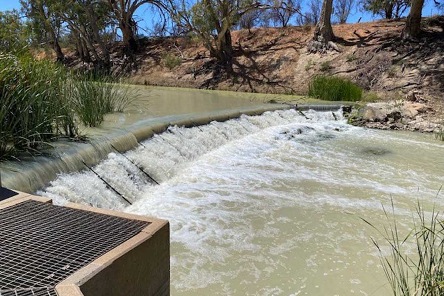 Water cascading over a low weir.