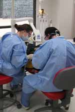 Second year oral health students Ms Stacey Webb from Forbes and Ms Megan Fontana from Coolamon treat a young patient in the Oral Health and Dental Clinic at CSU in Wagga Wagga.