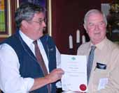 Professor Ted Wolfe (right) receives the AIAST honour from the Institute Director Mr Greg Fraser in Canberra. 