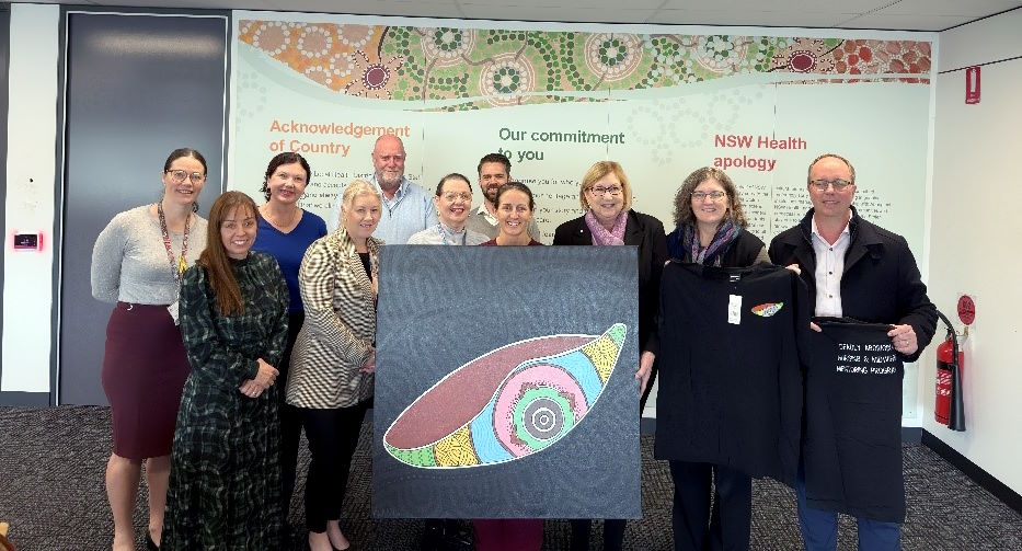 Researchers presenting project artwork to Murrumbidgee Local Health District Senior Executives July 2025