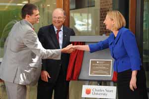 Parliamentary Secretary for Higher Education and Skills, the Hon. Sharon Bird MP shakes Vice-Chancellor Professor Andrew Vann's hand as Chancellor Mr Lawrence Willett looks on. 