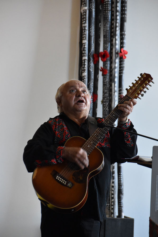 Uncle Johnny Huckle sings a song during the service