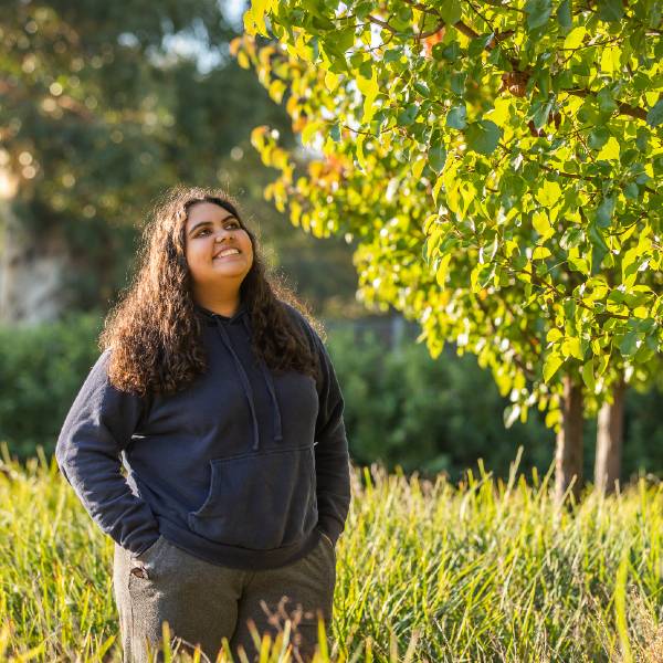 Student beside tree on Wagga Wagga campus