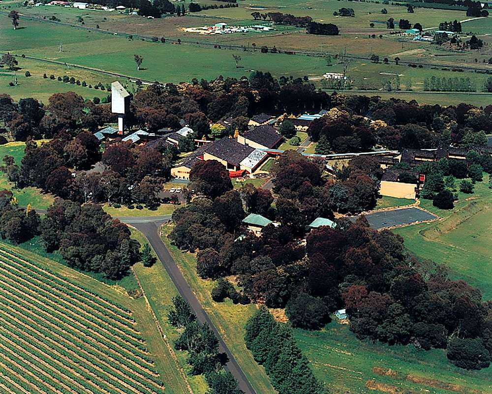 Aerial photo of Orange campus surrounded by trees and farms