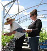 Dr Simon Clarke and Ms Emily Rouse from the NWGIC monitor plant growth in the new micro-vineyard. 