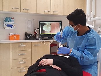 A student monitors the screen of an intraoral camera