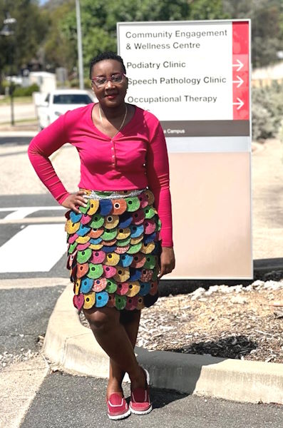 Josephine standing outside Charles Sturt University in the sun