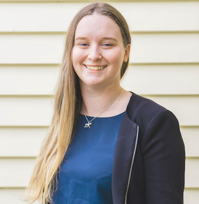 Morgan Heslop standing outside against a cladded wall