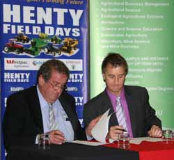Henty Machinery Field Day Chairman Mr Ross Edwards and Dean of the University's Faculty of Science Professor Nick Klomp check their signatures on the MoU.