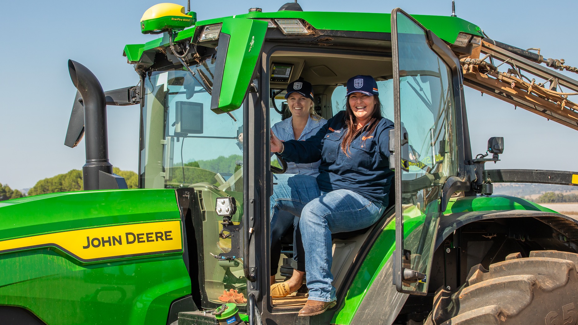 two women in a john deer tractor