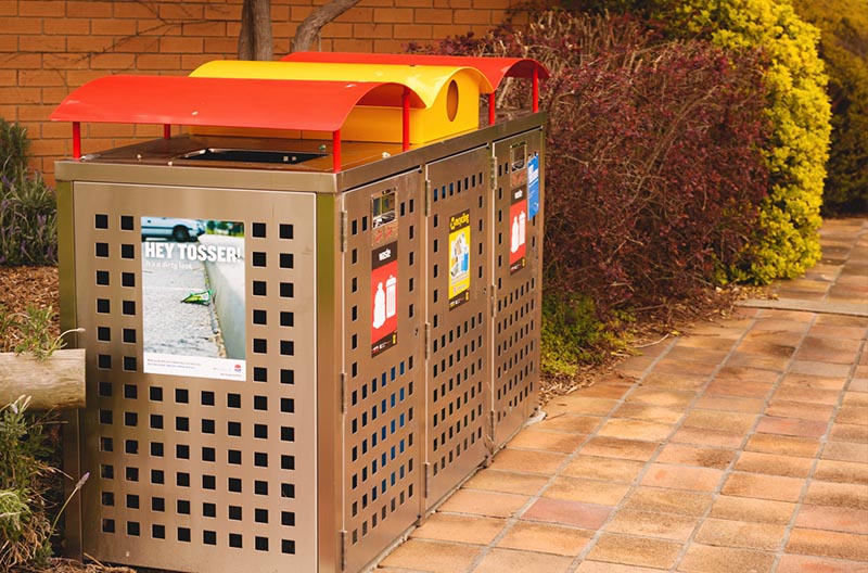 A waste bin station with bins for rubbish and recyclables.