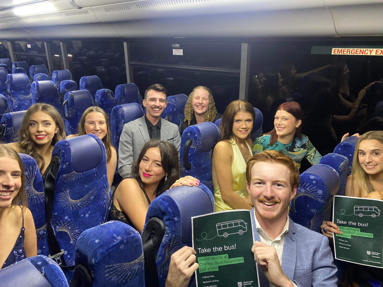 Vet Ball attendees on bus with promo flyers