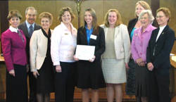 CSU Ontario graduate Elizabeth Wild, shown here at the Calgary Catholic School District's board meeting, holding a certificate that acknowledges that she was chosen as one of five "First Year Teachers of Excellence" for the Calgary Catholic School District