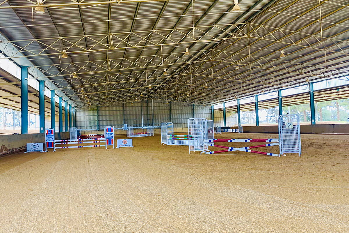Indoor view of the arena with jumps in position.