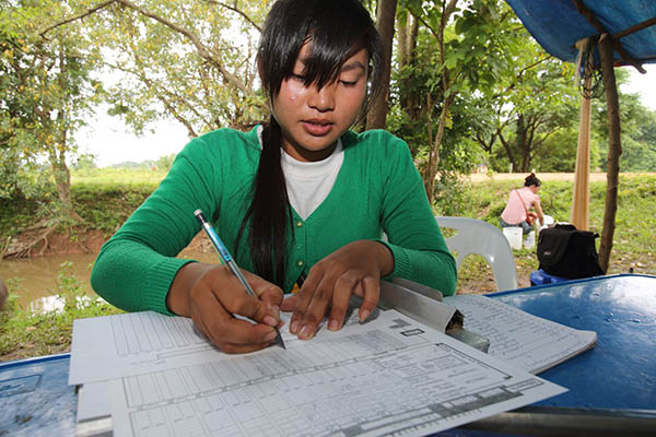 A local staff member recording data for an IFRG-led fish passage project at Pak Peung village in Lao PDR.