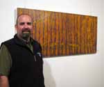 Artist Jason Kalt with his oil in canvas entitled Antediluvian.