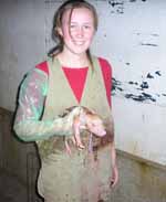 CSU veterinary science student Ms Jill Groat with a piglet.
