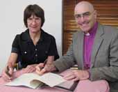 Deputy Vice Chancellor (Administration) Professor Lyn Gorman and  Bishop Stuart Robinson from the Anglican Diocese of Canberra and Goulburn sign the MoU on Monday 21 March.