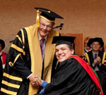 CSU Chancellor Lawrie Willett presents Mr Chad Pilon with his Bachelor of Primary Education Studies. 