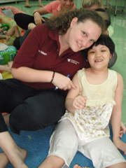 CSU physio student Ms Grace Pitts with an orphan in Vietnam