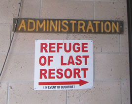 Sign about bushfire refuge on side of school