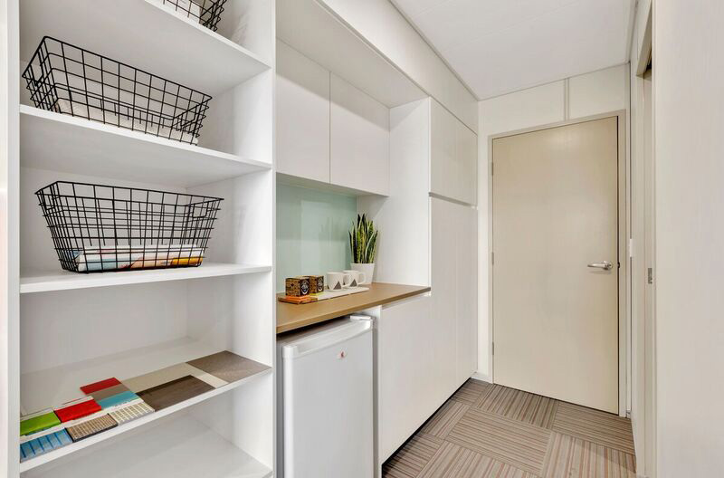 View of hallway showing storage, fridge and bench space