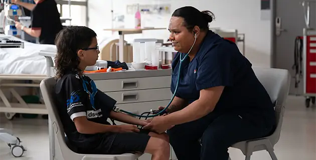 Nurse assisting young boy