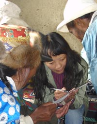 Yak researcher Baima Cuo speaks with yak herders in Tibet.