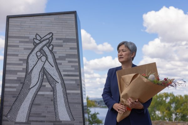 Foreign Minister Penny Wong lays flowers at ACC&C  Humanitarian Aid Monument