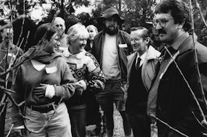 Old photo of a group of academics and farmers looking at trees