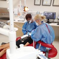 Two of our dentists working with a patient.